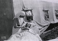 U.S. American National Red Cross Hospital No.5, Paris, France: Nurse with Patient at the Tent Hospital at Auteuil Race TrackCollection: Images from the History of Medicine (IHM) Format: Still image Extent: 1 photoprint. NLM Unique ID: 101405173 NLM Image ID: A011578 Permanent Link: resource.nlm.nih.gov/101405173