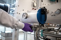 Stanford postdoctoral researcher Stephen Dongmin Kang works at a modular glovebox workstation in Lab 2098, located in the Arrillaga Science Center, Bldg. 57.