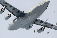 Air Force and Army conduct airborne operations at JBERArmy paratroopers from the 4th Infantry Brigade Combat Team (Airborne), 25th Infantry Division, U.S. Army Alaska, jump from a U.S. Air Force C-17 Globemaster III over Malemute Drop Zone during airborne training at Joint Base Elmendorf-Richardson, Alaska, March 24, 2022. Army and Air Force units regularly train together to strengthen and maintain joint mission readiness skills in an arctic environment. Airmen from the 176th Wing provided air support for the training. (U.S. Air Force photo by Alejandro Peña)