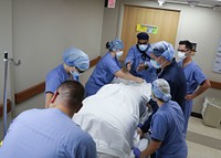 Navy Medical Team Supports Louisiana Hospital210821-N-PC620-0133LAFAYETTE, La. — U.S. Navy. Capt. Sean McKay, a physician from Navy Medicine Readiness and Training Command Bethesda and the medical support team (MST) senior medical officer, back middle, directs MST members how to move a mock patient to the prone position at Ochsner Lafayette General Medical Center during the COVID-19 response operations in Lafayette, Louisiana, Aug. 21, 2021. U.S. Northern Command, through U.S. Army North, remains committed to providing flexible Department of Defense support to the whole-of-government COVID-19 response. (U.S. Navy photo by Mass Communication Specialist 2nd Class Michael H. Lehman/Released)