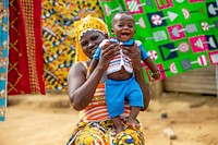 Mother and child outside their home.