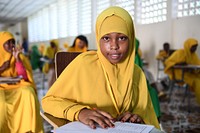 Class 8 girl student writes an English paper during the national Primary Education Certificate examinations in Mogadishu, Somalia, May 26, 2021. AMISOM Photo / Mokhtar Mohamed. Original public domain image from Flickr