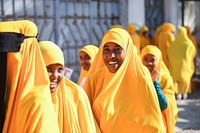 Female students stand outside an examination center after doing the national Primary Education Certificate examinations in Mogadishu, Somalia, on May 26, 2021. AMISOM Photo / Mokhtar Mohamed. Original public domain image from Flickr