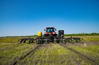 Tractor planting soybean seeds. Original public domain image from Flickr