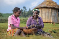 Two women pictured close by to a mass mosquito net distribution campaign