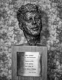 Bust of John F. Kennedy in main entranceway of the National Library of Medicine. Image caption on page 76 of the book US National Library of Medicine: "This bust of John F. Kennedy by Robert Berks is located today in main entranceway of the library. It is a replica of the large bust located in the grand foyer of the Kennedy Center for the Performing Arts in Washington, DC. Courtesy of Stephen J. Greenberg." Original public domain image from Flickr