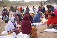 Internally Displaced Persons (IDPs) affected by recent flooding waiting to receive food at a distribution point in Jowhar, HirShabelle State of Somalia. 29 June 2021. (AMISOM Photo) Original public domain image from Flickr