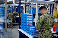 US Navy Hospital Corpsmen checking glasses during the manufacturing process at the Naval Ophthalmic Support and Training Activity (NOSTRA) facility in Yorktown, Virginia. June 16, 2021. (US Navy photo by Cmdr. Denver Applehans/Released) Original public domain image from Flickr