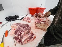 Butcher shop operations includes removing debris left after band saw cuts at Rustic Cuts in Council Bluffs, IA. Original public domain image from Flickr