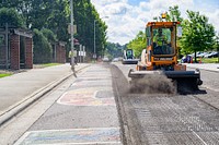 Crews begin removing asphalt along First Street at Town Common where the Unite Against Racism mural was located, between Cotanche and Washington Streets, July 12, 2021.  Original public domain image from Flickr