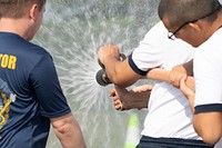 Midshipmen 4th Class, or plebes, from the United States Naval Academy Class of 2025, participate in damage control training during Plebe Summer. (U.S. Navy photo by Stacy Godfrey/Released). Annapolis, Md, July 22, 2021. Original public domain image from Flickr