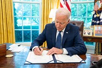 President Joe Biden signs S.409, an Act “to provide the availability of amounts for customer education initiatives and non-awards expenses of the Commodity Futures Trading Commission Whistleblower Program, and for other purposes,” on Tuesday, July 6, 2021, in the Oval Office of the White House. (Official White House Photo by Adam Schultz). Original public domain image from Flickr