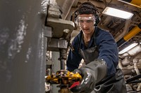 Fireman Michael Merz cleans an oil strainer aboard the Wasp-class amphibious assault ship USS Kearsarge (LHD 3) (U.S. Navy photo by Mass Communication Specialist Seaman Gwyneth Vandevender). Atlantic Ocean, August 3, 2021.  Original public domain image from Flickr