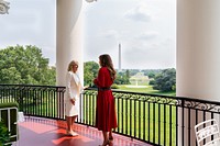 First Lady Jill Biden and Queen Rania of Jordan look out over the South Lawn of the White House and the Washington Monument, Monday July 19, 2021, on the Truman Balcony of the White House. (Official White House Photo by Cameron Smith). Original public domain image from Flickr