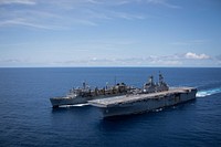  The Wasp-class amphibious assault ship USS Kearsarge sails alongside the fast combat support ship USNS Arctic to prepare for a replenishment-at-sea. Original public domain image from Flickr