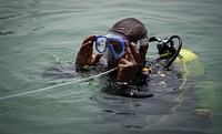 Expert U.S. Navy divers teach foreign partners how to perform diver communication techniques using line pull signals during exercise Cutlass Express 21 at the International Port of Djibouti, August 2, 2021. (U.S. Air Force Photo by Staff Sgt. Christopher Dyer/Released). Original public domain image from Flickr