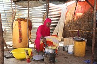 Somalian woman cooking in the kitchen. Original public domain image from Flickr