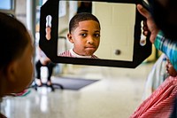 Cops & Barbers provided haircuts to students during a free haircut event at Lakeforest Elementary School October 17, 2022, North Carolina, USA. Original public domain image from Flickr