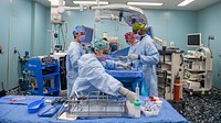 Continuing Promise 2022 - Surgery221027-N-DF135-1161 PUERTO BARRIOS, Guatemala (Oct. 27, 2022) – Hospital Corpsman 3rd Class Monica Martinez, from Edinburg, Texas, front, reaches for surgical instruments during a laparoscopic cholecystectomy aboard the hospital ship USNS Comfort (T-AH 20), Oct. 27, 2022. Comfort is deployed to U.S. 4th Fleet in support of Continuing Promise 2022, a humanitarian assistance and goodwill mission conducting direct medical care, expeditionary veterinary care, and subject matter expert exchanges with five partner nations in the Caribbean, Central and South America. (U.S. Navy photo by Mass Communication Specialist Seaman Deven Fernandez)