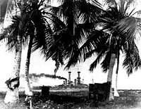 View from shore of Guantanamo Bay, Cuba, with USS North Dakota (BB-29) in the background. Courtesy of ChPhm Gustave Maurer, USN, 1921. NH 43310.