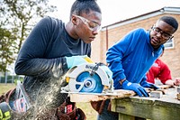 Students learning the basics of cutting with a skill saw, Greenville, 2-23. Original public domain image from Flickr