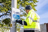 Engineering and Parking Enforcement staff install new signage ahead of public parking changes in Uptown Greenville on Monday, November 14. Original public domain image from Flickr