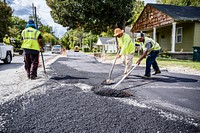 Construction on the greenway extension from Pitt Street to Memorial Drive nears completion as workers apply pavement to the new trail, October, 2021. Original public domain image from Flickr