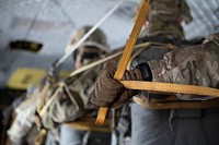 A U.S. Air Force Airman, a Detachment 1, 3rd Air Support Operations Squadron tactical air control party (TACP) specialist, prepares to jump out of a U.S. Army CH-47 Chinook helicopter assigned to B Company, 2-211th General Support Aviation Battalion, Alaska Army National Guard, while completing airborne operations at Joint Base Elmendorf-Richardson, Alaska.