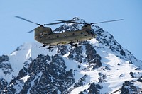 An Alaska Army National Guard CH-47 Chinook helicopter, operated by Army aircrew assigned to B Company, 2-211th General Support Aviation Battalion, approaches Geronimo Drop Zone while supporting airborne training at Joint Base Elmendorf-Richardson, Alaska, April 7, 2022. Special warfare Airmen from Detachment 1, 3rd Air Support Operations Squadron and Detachment 3, 1st Combat Weather Squadron, conducted the training to demonstrate airborne and mission-readiness skills in an arctic environment. (U.S. Air Force photo by Alejandro Peña)