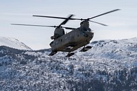 An Alaska Army National Guard CH-47 Chinook helicopter assigned to B Company, 2-211th General Support Aviation Battalion, flies over Bryant Army Airfield at Joint Base Elmendorf-Richardson, Alaska, April 7, 2022. The 2-211 GSAB supported a helicopter jump for the U.S. Air Force Detachment 1, 3rd Air Support Operations Squadron on Geronimo Drop Zone, maximizing total-force training to demonstrate short-notice mission readiness in an arctic environment. (U.S. Air Force photo by Senior Airman Emily Farnsworth)
