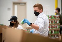 DHS Deputy Secretary Tien Volunteers at Capital Area Food BankWashington, D.C. (April 21, 2022) Homeland Security Deputy Secretary John Tien, alongside Veterans Affairs Deputy Secretary Donald Remy, receives a tour of the Capital Area Food Bank and helps to sort and pack donated food into boxes for distribution as part of VetServe 2022. VetServe 2022 is a campaign to strengthen volunteer capacity across the nation with military veterans. (DHS Photo by Benjamin Applebaum)