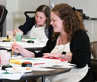 FAP Paint_06Fort Drum family members concentrate on their painting, while experiencing the therapeutic benefits of creative arts during the Family Advocacy Program’s “Paint More, Stress Less” workshop May 25 at the Main Post Chapel. Fort Drum FAP staff designed the program to help community members learn about stress management in a fun and interactive way. (Photo by Mike Strasser, Fort Drum Garrison Public Affairs)