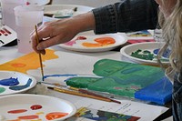 Fort Drum family members concentrate on their painting, while experiencing the therapeutic benefits of creative arts during the Family Advocacy Program’s “Paint More, Stress Less” workshop May 25 at the Main Post Chapel. 