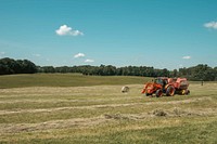 Tractor preparing hay bales.