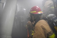 Sailors combat a simulated fire aboard the Arleigh Burke-class guided-missile destroyer USS Paul Ignatius.