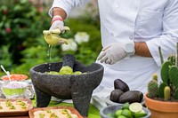 Kitchen staff prepares guacamole.