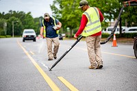 Pavement crack sealing being performed along Red Banks Road, Greenville, June 14, 2022. Original public domain image from Flickr