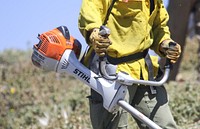 MAY 16: Using brushcutters to manage a fuel breakKINGMAN, AZ - MAY 16: A firefighter uses a brushcutter to trim fuels on a fuel break surrounding the community of Pine Lake, south of Kingman, Arizona on Monday, May 16 2022. Photo by Suzanne Allman, contract photographer for BLM