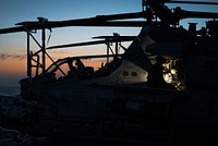 220715-N-TP544-1000 ATLANTIC OCEAN (July 15, 2022) A U.S. Marine performs maintenance on an AH-1Z Viper helicopter, attached to the 22nd Marine Expeditionary Unit (MEU), on the flight deck of the Wasp-class amphibious assault ship USS Kearsarge (LHD 3) during night flight operations, July 15, 2022. The Kearsarge Amphibious Ready Group and embarked 22nd MEU, under the command and control of Task Force 61/2, is on a scheduled deployment in the U.S. Naval Forces Europe area of operations, employed by U.S. Sixth Fleet to defend U.S., allied and partner interests. (U.S. Navy photo by Mass Communication Specialist 3rd Class Taylor Parker)