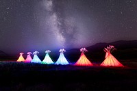 Illuminated teepees and Milky Way at North Entrance in Gardiner, Montana.