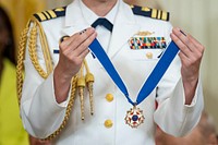 A military aide stands by while President Joe Biden presents the Medal of Freedom to Sister Simone Campbell, Thursday, July 7, 2022, in the East Room of the White House. (Official White House Photo by Adam Schultz)