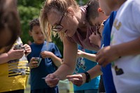 Students from the Royalton-Hartland School District's elementary school in Gasport, NY, on May 26, 2022. Students are taught basic gardening, soil conservation with worms, planting a pollinator garden, and raising butterflies to be set free at the garden. Royalton-Hartland School District, comprised of an elementary, middle, and high school, has approximately 1,300 K-12 students in Middleport, NY, which is a remote, rural part of eastern Niagara County. Royalton-Hartland School District received a FY 2021 Farm to School Implementation grant to provide engaging, hands-on programming that promotes a healthy lifestyle; increases student knowledge of how to grow, prepare, and store fresh produce; and exposes students to the multitude of career opportunities in the growing local agriculture industry. In collaboration with district partners, including Cornell Cooperative Extension of Niagara County, Blackman Family Farms, and the Royalton-Hartland Agriculture Foundation, Royalton-Hartland School District is in the process of developing a K-12 curriculum, engaging teachers in the integration of the farm to school vision on a district-wide basis, equipping kitchen facilities to increase the capacity to store, prepare and serve locally sourced foods, and upgrading classrooms for project-based learning experiences. USDA Media by Lance Cheung.