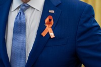 President Joe Biden, wearing an orange ribbon for gun violence awareness, greets U.S. Senator Chris Murphy, D-Conn. and his family before an event celebrating the passage of the Bipartisan Safer Communities Act, Monday, July 11, 2022, in the Oval Office. (Official White House Photo by Adam Schultz)