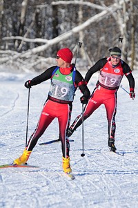 U.S. Air Force Capt. Eric Nordgren, right, with the North Dakota Air National Guards 119th Wing, races up to U.S. Army Sgt. 1st Class Kent Pulst, with the North Dakota National Guards 3662nd Maintenance Company, during a relay exchange at the Central Region Biathlon championships at Camp Ripley, Little Falls, Minn., Jan. 15, 2011.