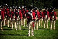 U.S. Soldiers with the Old Guard Fife and Drum Corps stand on the parade field at the Pentagon during the armed forces farewell tribute honoring departing Secretary of Defense Robert M. Gates June 30, 2011.