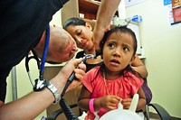 POHNPEI, Federated States of Micronesia (July 12, 2011) Lt. Cmdr. Cory Russell examines the ear canal of a Micronesian girl at Pohnpei Hospital during a Pacific Partnership 2011 medical community service project.