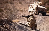 U.S. Marine Corps Lance Cpl. Justin Downing, a mortar man with 3rd Battalion, 3rd Marine Regiment, scans his area while on patrol during Exercise Clear, Hold, Build 3 at Marine Corps Air Ground Combat Center Twentynine Palms, Calif., Sept. 21, 2011.