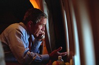 After departing Offutt Air Force Base in Nebraska for Washington, D.C. Tuesday, Sept. 11, 2001, President George W. Bush talks on the phone with Vice President Dick Cheney from Air Force One, 09/11/2001. Original public domain image from Flickr