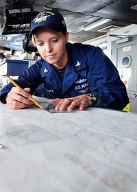 U.S. Navy Quartermaster 3rd Class Jennifer Boyle plots a chart on the bridge of the aircraft carrier USS Ronald Reagan (CVN 76) in the Pacific Ocean Oct. 24, 2011.