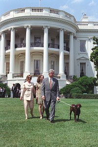 Photograph of President William Jefferson Clinton, First Lady Hillary Rodham Clinton, Chelsea Clinton, and Buddy the Dog Walking on the South Lawn: 07/24/1998. Original public domain image from Flickr